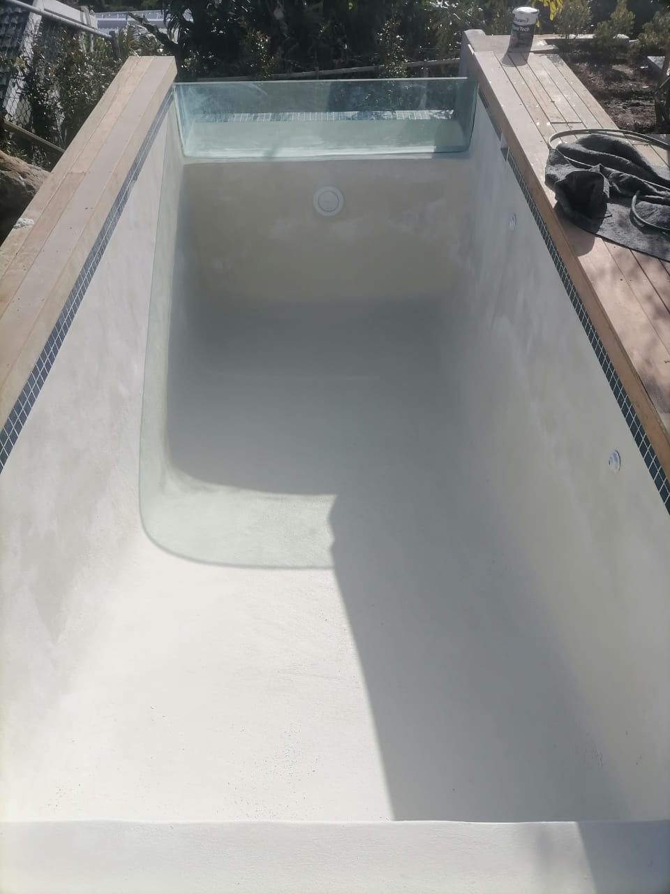 Freshly finished Cape Town swimming pool with a smooth new surface and glass edge
