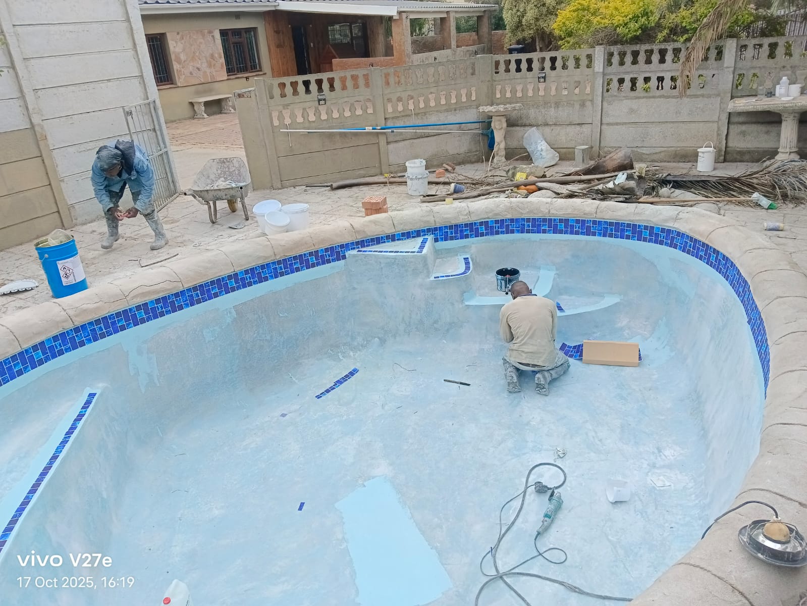 Kwik Pools technicians applying new marbelite to a swimming pool during resurfacing in Cape Town