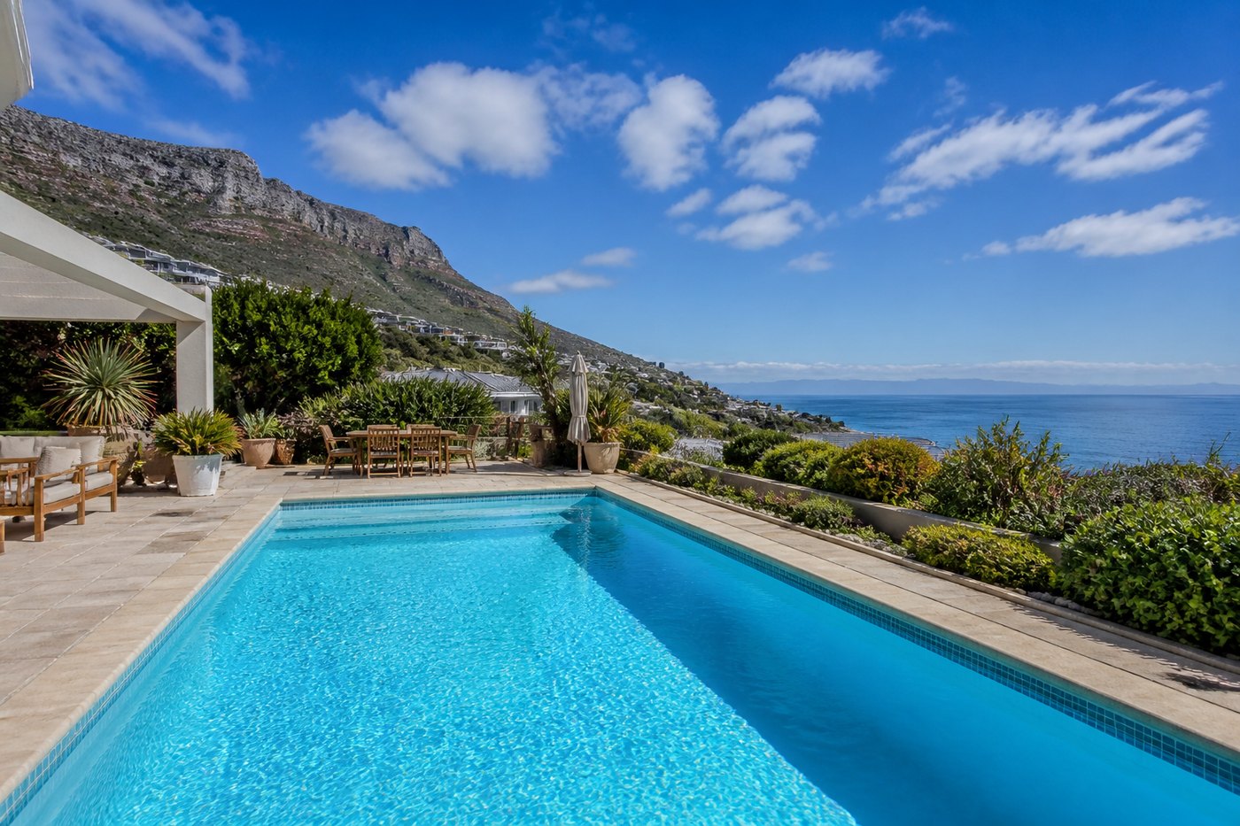 Swimming pool at a South Peninsula home near Fish Hoek with False Bay views and a coastal fynbos garden