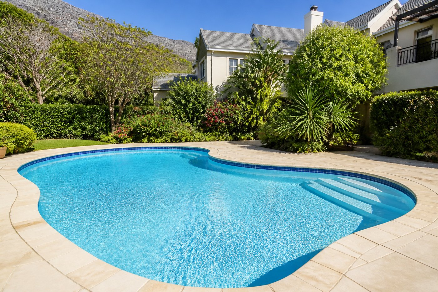 Restored Cape Town swimming pool with clear blue water, new marbelite surface and mosaic waterline tiles, holding its level